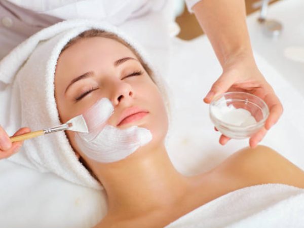Woman in mask on face in spa beauty salon.